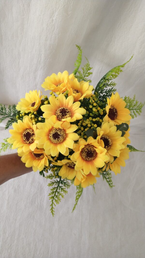 Sunflower bouquet with yellow blooms and green foliage.